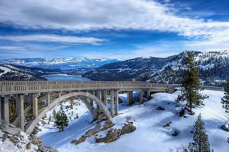 Donner Summit Bridge (Rainbow Bridge) on Donner Pass Road, plowed in winter, with Donner Lake below